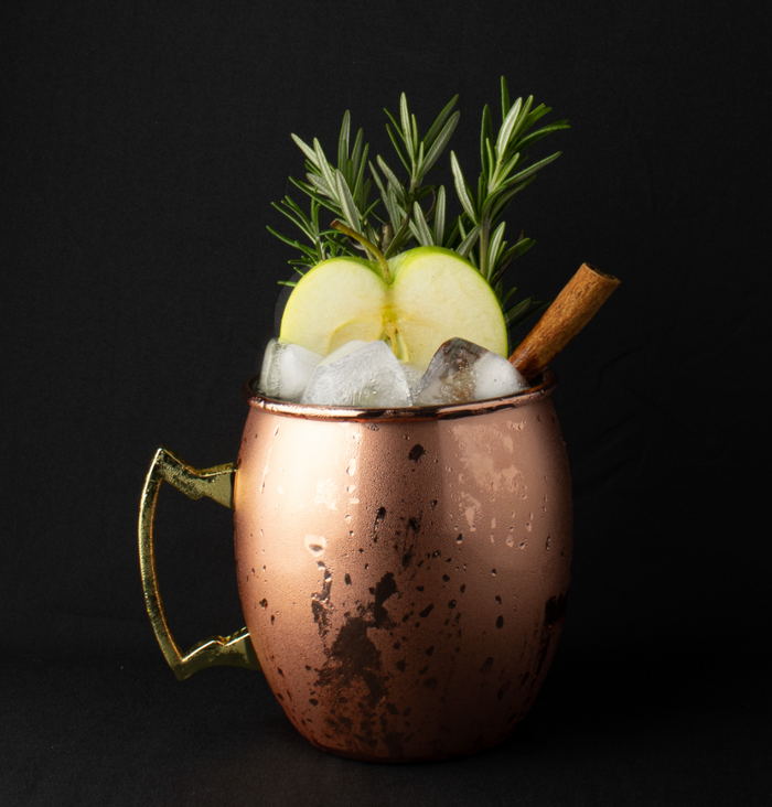 Image of a Spiced Apple Mule Mocktail in a Brass cup.